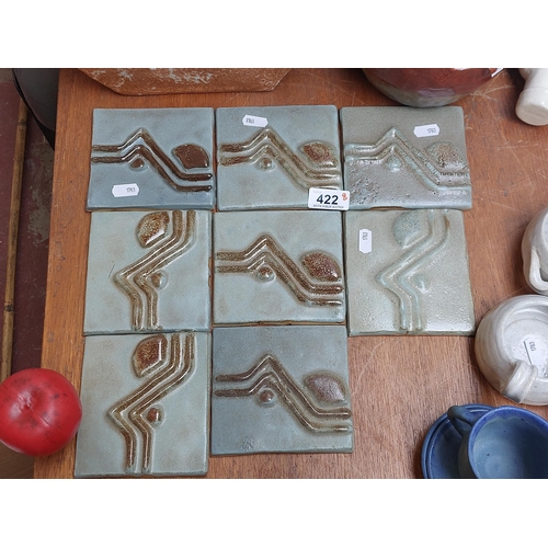 422 - A gorgeous set of eight studio pottery decorative two tone ceramic tiles.