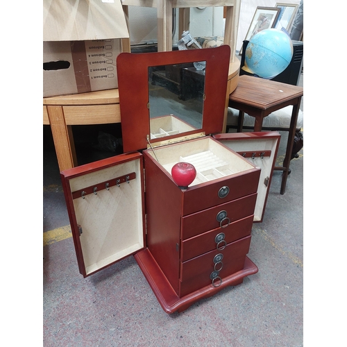 445 - A charming rosewood large jewellery box.  boasting five pull out drawers and mirrored flip up top.