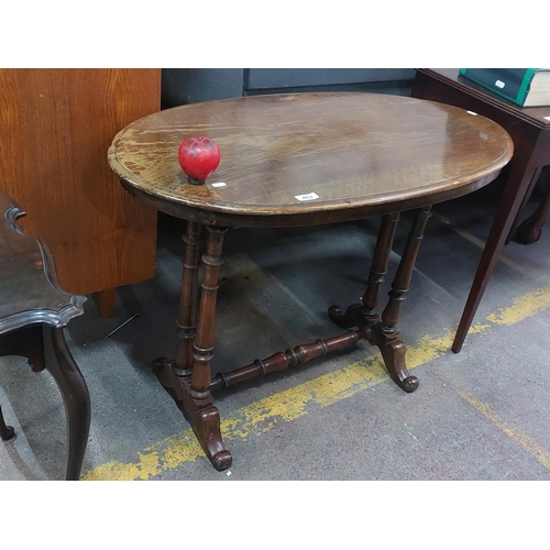 463 - An splendid early 20th century oval center table supported by four turned and shaped columns, raised... 