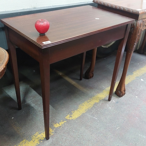 464 - A very robust sleek console table with tapered legs.