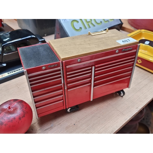 487 - A fantastic Snap-on model tool chest locker with pop out drawers holding miniature tools. In a red f... 