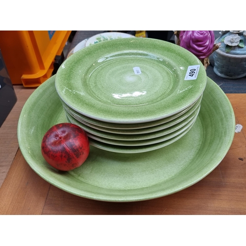 A lovely high quality  Mateus handmade table service consisting of six plates and a large serving platter. All in a stylish green glaze. In very good condition.