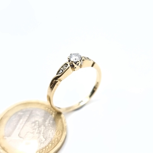 501 - Star Lot : A very pretty 9K gold diamond ring with twist set mount, size O, weight 2 grams, boxed.