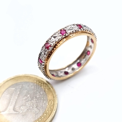 504 - Star Lot : A 9K gold diamond and ruby full eternity ring, size R, weight 3.02 grams, boxed.