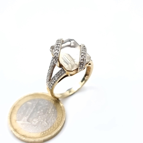 509 - Star Lot : An unusual large rock crystal stone ring with a double diamond set mount, mounted in 9K g... 