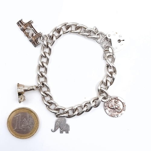 532 - A four charm sterling silver bracelet with padlock clasp and safety chain, weight 36.43 grams.