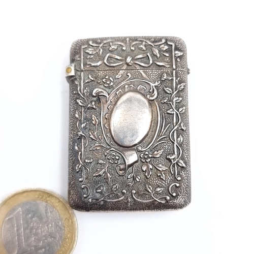 540 - A sterling silver vesta case hallmarked London with profusely decorated, hallmarked London, marks in... 