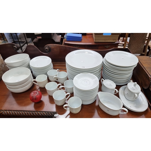 705 - A very large and impressive pure white dinner service containing plates, saucers, bowls and cups. So... 