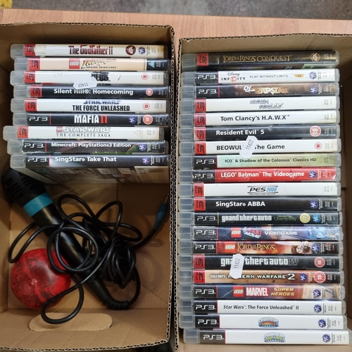 714 - Two boxes containing a large selection of Playstation 3 games and a Sony Microphone.