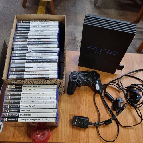 715 - Two boxes containing a PlayStation 2 along with controllers and a selection of games.