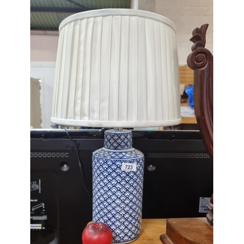 723 - A beautiful tall ceramic table lamp featuring a two tone blue and white pattern and a large circular... 