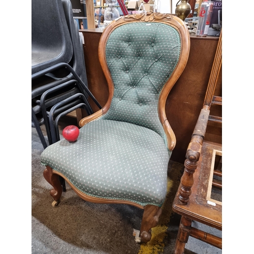 729 - A Victorian walnut Spoon back fully upholstered ladies parlour chair featuring button back detail an... 