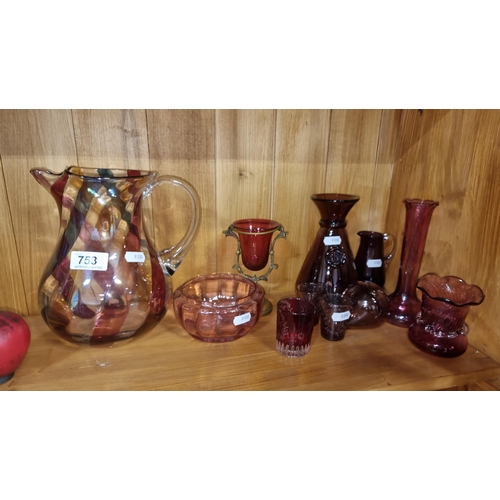 753 - Eleven gorgeous pieces of cranberry glass including a large water pitcher, a fluted vase and a nicel... 