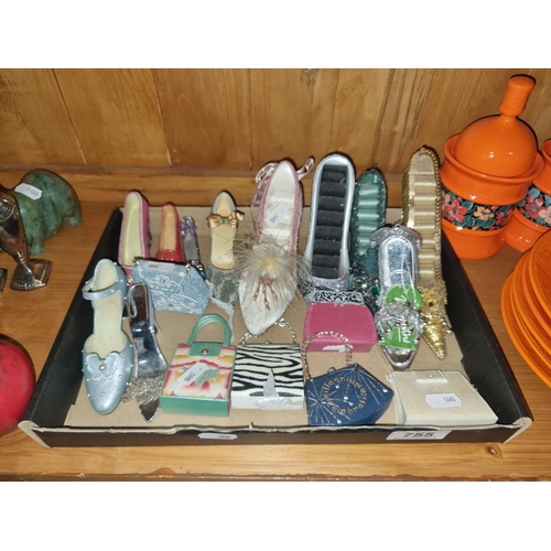 755 - A box containing a large selection of miniature decorative items including shoes and handbags.