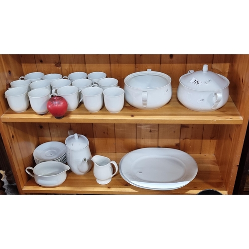 779 - A large impressive approx.30 piece dinner service comprising of serving platters, cups, milk jug, gr... 