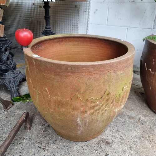 811 - A very large terracotta planter with abstract mountain range design.