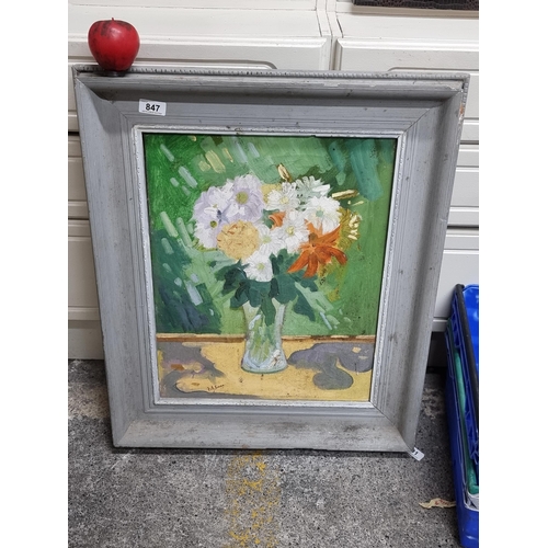 847 - An original Irish School oil on board painting featuring a still life of flowers in a vase. Rendered... 