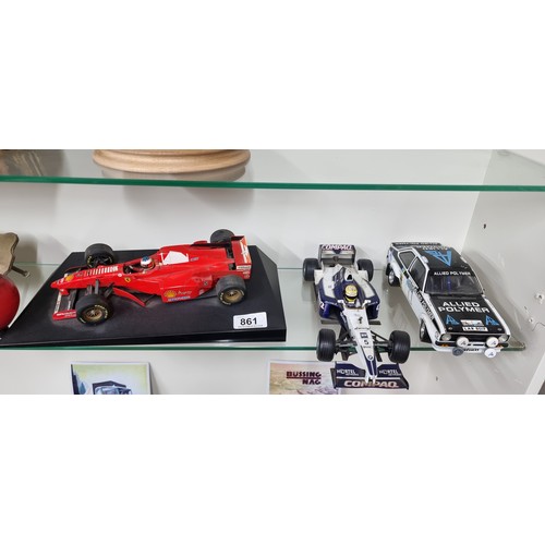 861 - Three amazing model cars, Including a vibrant red Formula 1 Ferrari reinforced by a black surface, a... 