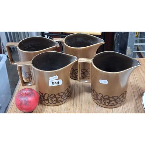 844 - Four matching vintage earthenware pitchers by Celtic Limerick, in a soft brown glaze with floral bor... 