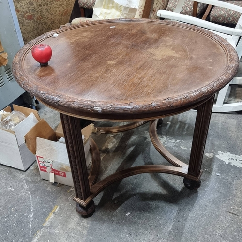 1000 - Star lot : A lovely Ornate tall  mahogany coffee table with intricately carved edges, showcasing tra... 