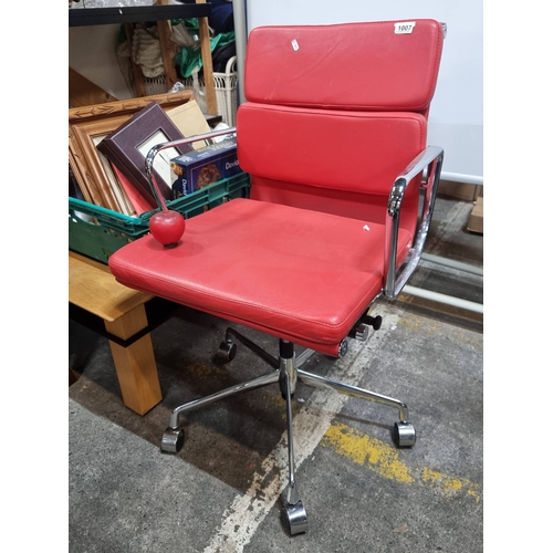 1007 - Star Lot : A Charles Eames style soft pad striking red leather swivel chair with chrome frame. In ni... 