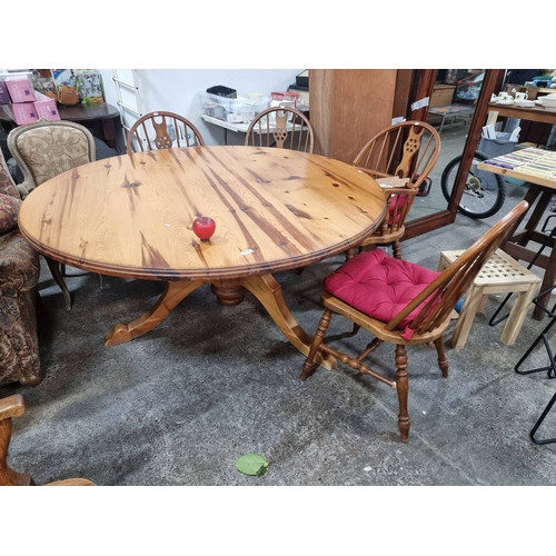 974 - Star Lot : A large Pine round dining table set, radiating classic charm with an inviting patina and ... 