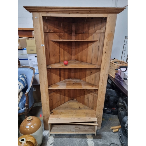 981 - Star Lot : A large Vintage pine corner shelf unit exuding rustic charm with ample storage space. The... 