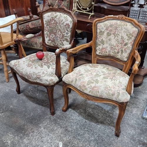 988 - Elegant French Louis XV-style armchairs, showcasing exquisite floral upholstery and rich walnut fram... 