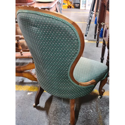 729 - A Victorian walnut Spoon back fully upholstered ladies parlour chair featuring button back detail an... 