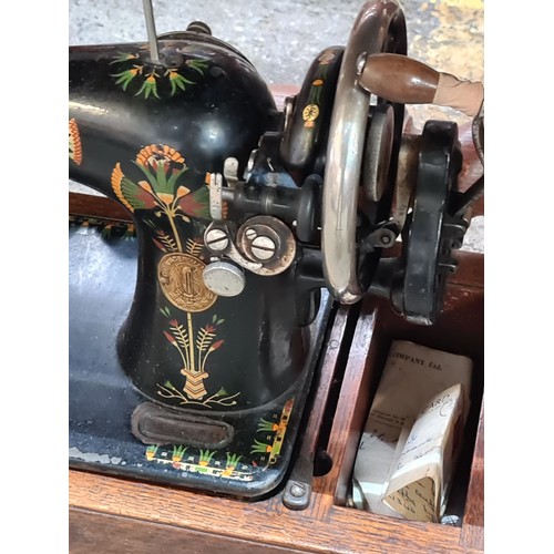 791 - A superb 1930's Singer sewing machine hand painted with floral decoration and sat in its original ca... 