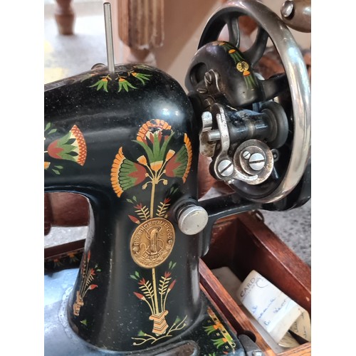 791 - A superb 1930's Singer sewing machine hand painted with floral decoration and sat in its original ca... 