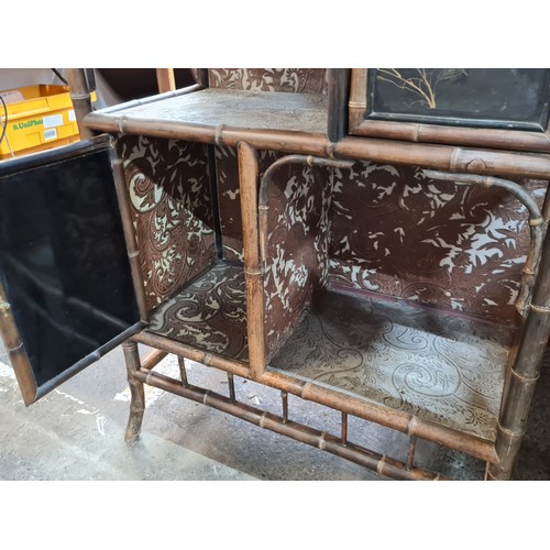 796 - Star Lot : An incredible 19th century lacquered bamboo cabinet boasting three cupboards with door lo... 