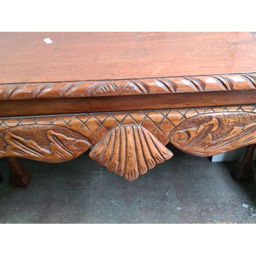 465 - A gorgeous large console table with intricately carved detailing to apron and carved gadrooning, sup... 