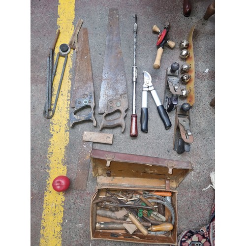 447 - A very good box containing a large quantity of vintage hand tools. Including planes, cow bells, unus... 