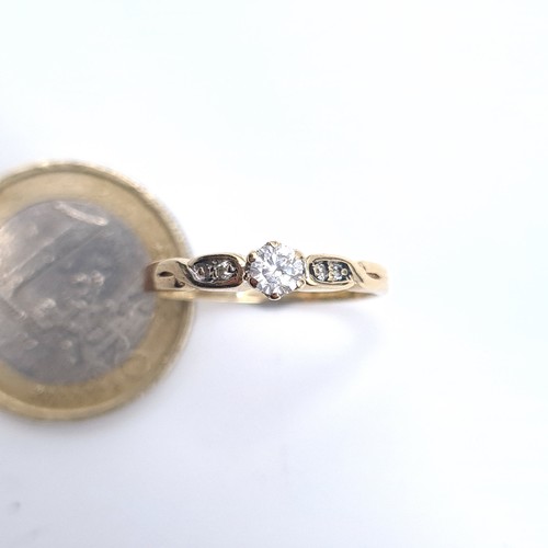 501 - Star Lot : A very pretty 9K gold diamond ring with twist set mount, size O, weight 2 grams, boxed.