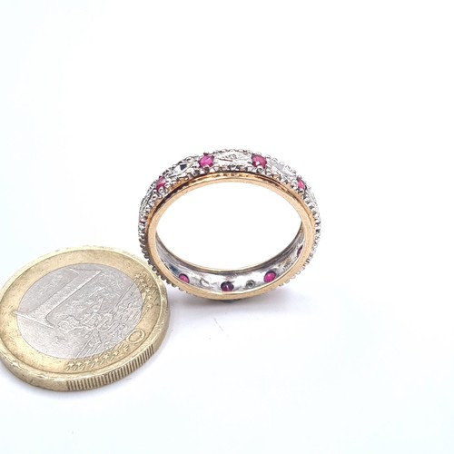 504 - Star Lot : A 9K gold diamond and ruby full eternity ring, size R, weight 3.02 grams, boxed.