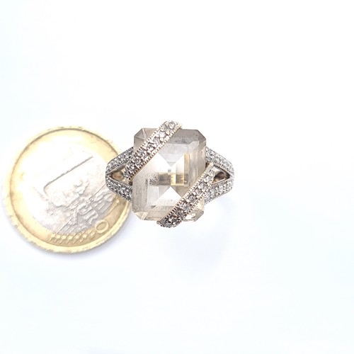 509 - Star Lot : An unusual large rock crystal stone ring with a double diamond set mount, mounted in 9K g... 