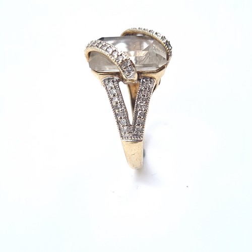 509 - Star Lot : An unusual large rock crystal stone ring with a double diamond set mount, mounted in 9K g... 