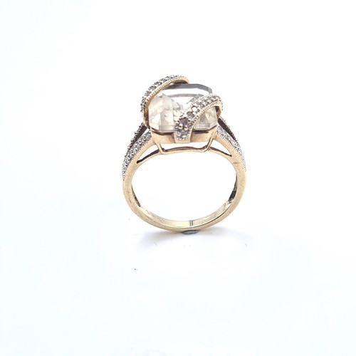 509 - Star Lot : An unusual large rock crystal stone ring with a double diamond set mount, mounted in 9K g... 