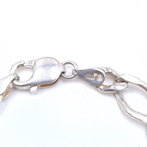 517 - A sterling silver chain link bracelet, weight 23.46 grams, boxed.