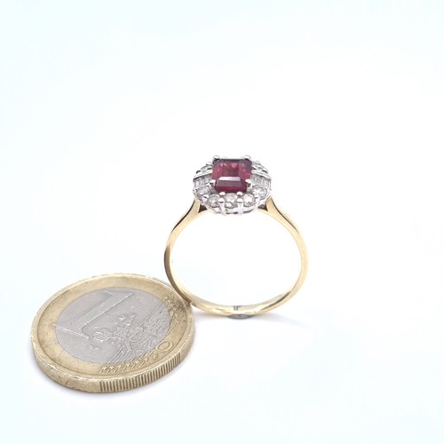 521 - A 9K gold garnet stone ring with gem stone surround, size P, weight 2.9 grams, boxed.