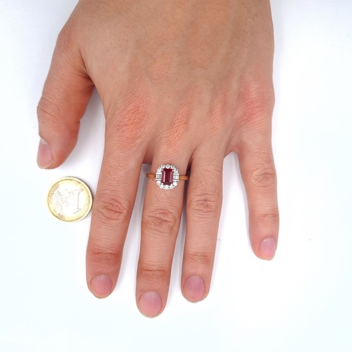 521 - A 9K gold garnet stone ring with gem stone surround, size P, weight 2.9 grams, boxed.