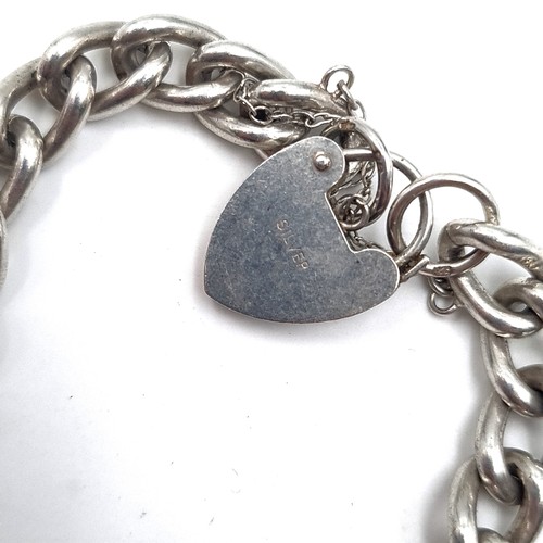 532 - A four charm sterling silver bracelet with padlock clasp and safety chain, weight 36.43 grams.