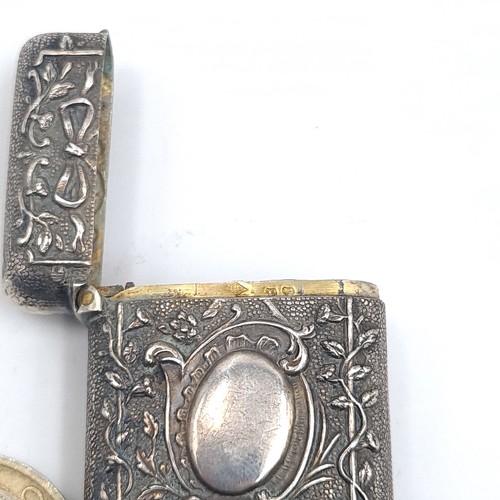 540 - A sterling silver vesta case hallmarked London with profusely decorated, hallmarked London, marks in... 