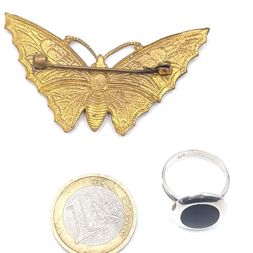 541 - A sterling silver onyx ring, size L, weight 3.85 grams together with an enamelled butterfly brooch, ... 