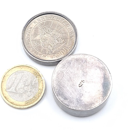 547 - A sterling silver ring dish set with an Indonesian bank coin lid, 3cm diameter, weight 19.21 grams.