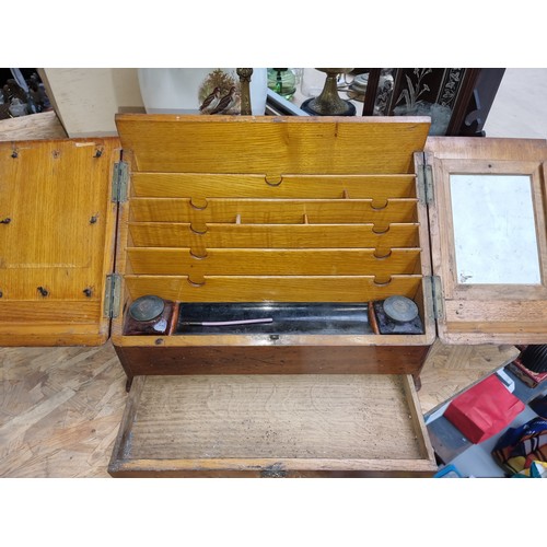 224 - A handsome antique 19th century desk top stationary cupboard in oak opens to reveal dividers and two... 