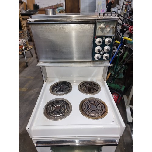 1001 - STAR LOT : A 1972  white vintage electric range, chrome accents, complete with analog controls, a un... 