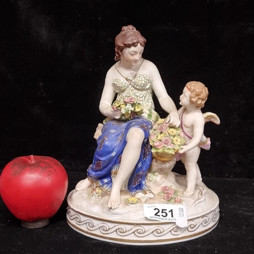 251 - A stunning Masons ceramic figurine depicting a woman making a flower crown with a cherub beside her.