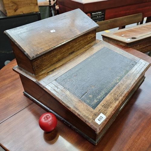 Star Lot: A 19th century desk top writing slope with tooled leather top and two compartments that lift up for storage.